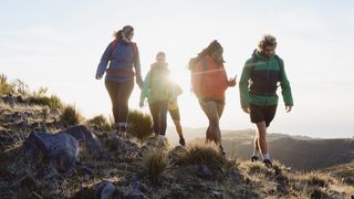 four hill walkers wearing gore-tex jackets