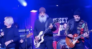 Kim Thayil (middle) performs onstage at the Whisky A Go Go with two attendees of the Rock 'n' Roll Fantasy Camp