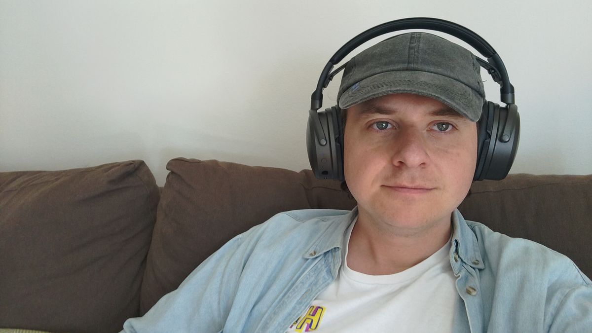 Photograph of man wearing Audeze Maxwell 2 headphones (they are very large)