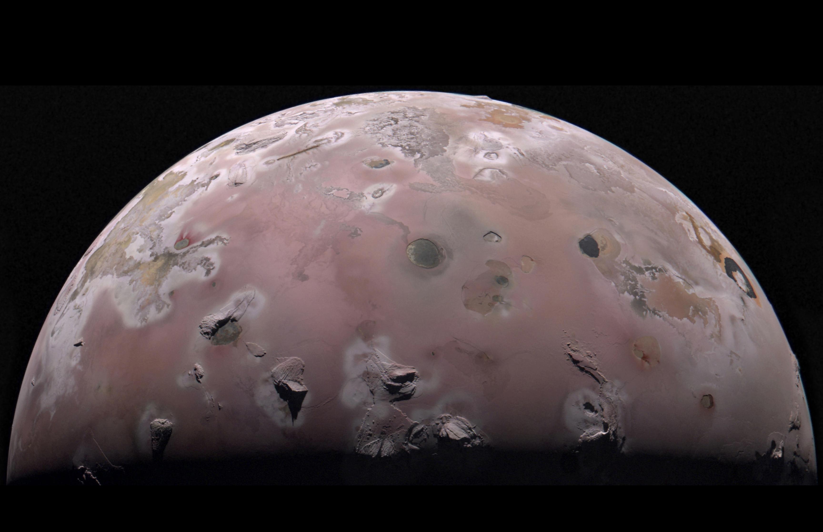 IO is seen in this image, with volcanoes on its surface.