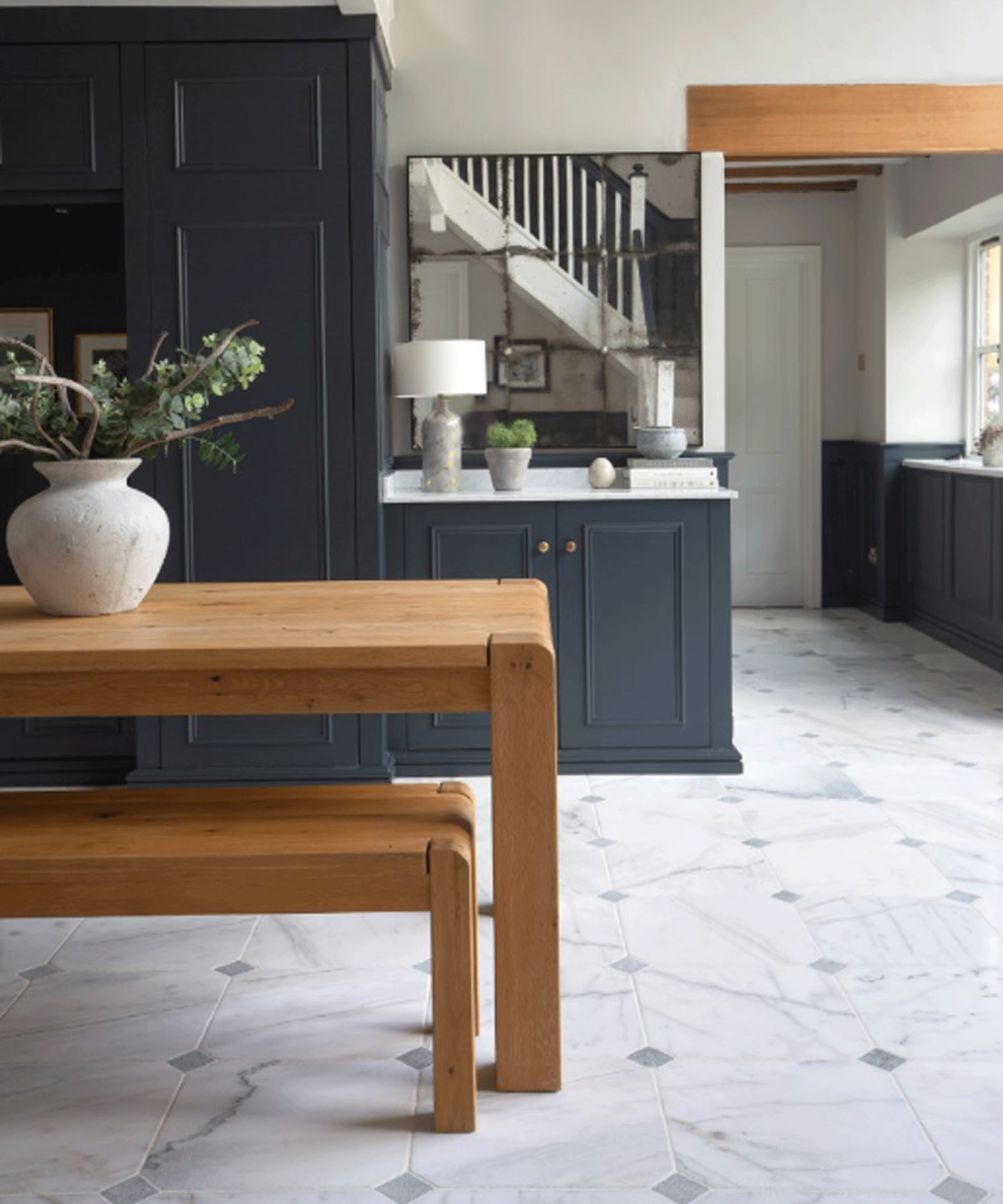 grey kitchen with marble flooring and wooden dining table