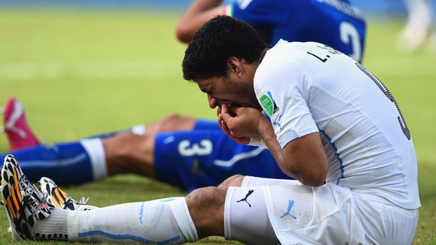 Luis Suarez and Giorgio Chiellini after their clash in Natal