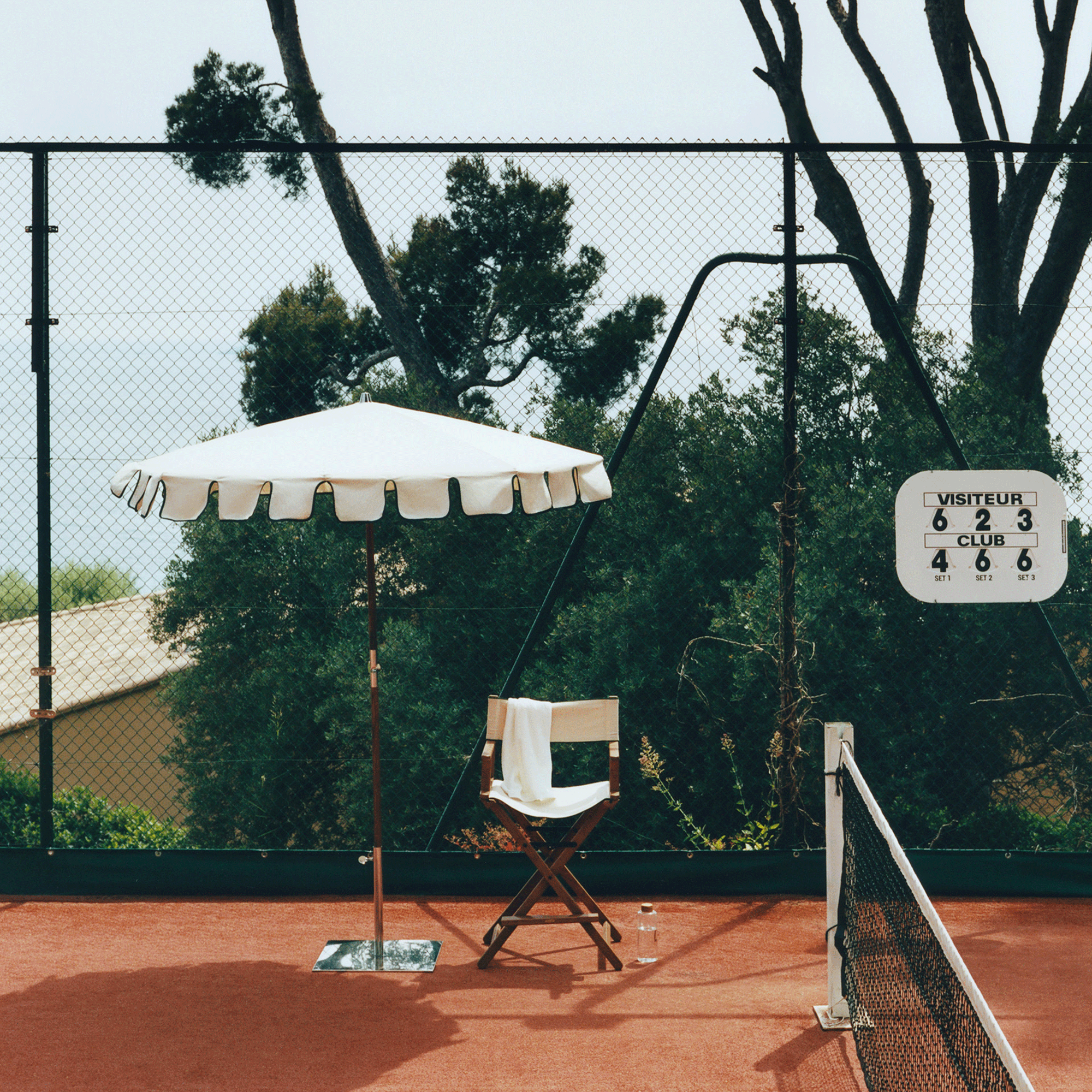 Zara Home collection styled on tennis court with outdoor umbrella