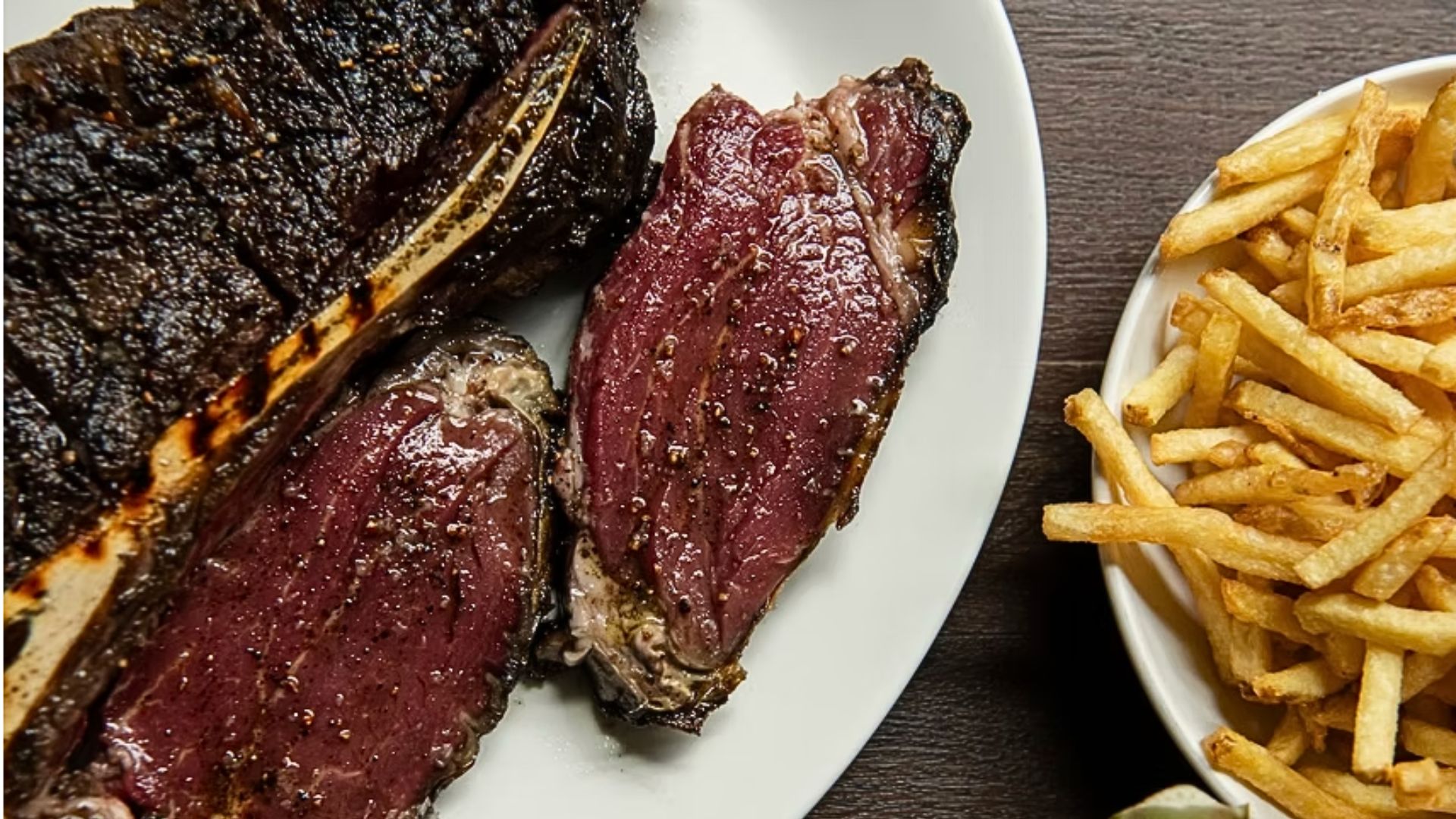 an image of the steak on a plate from Ibai with a side of fries next to it