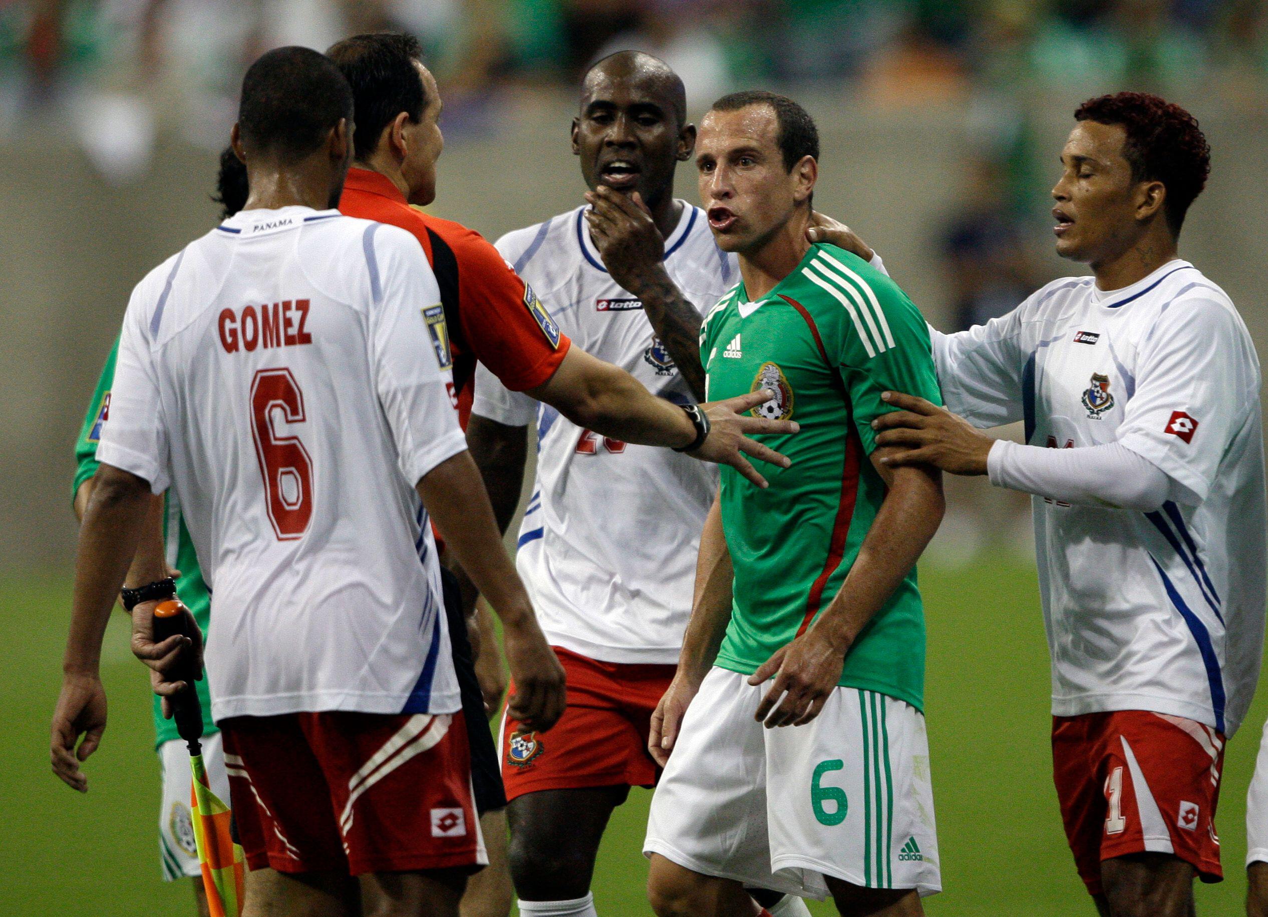 Gerardo Torrado is held back by Panama players during Mexico's 2009 CONCACAF Gold Cup match