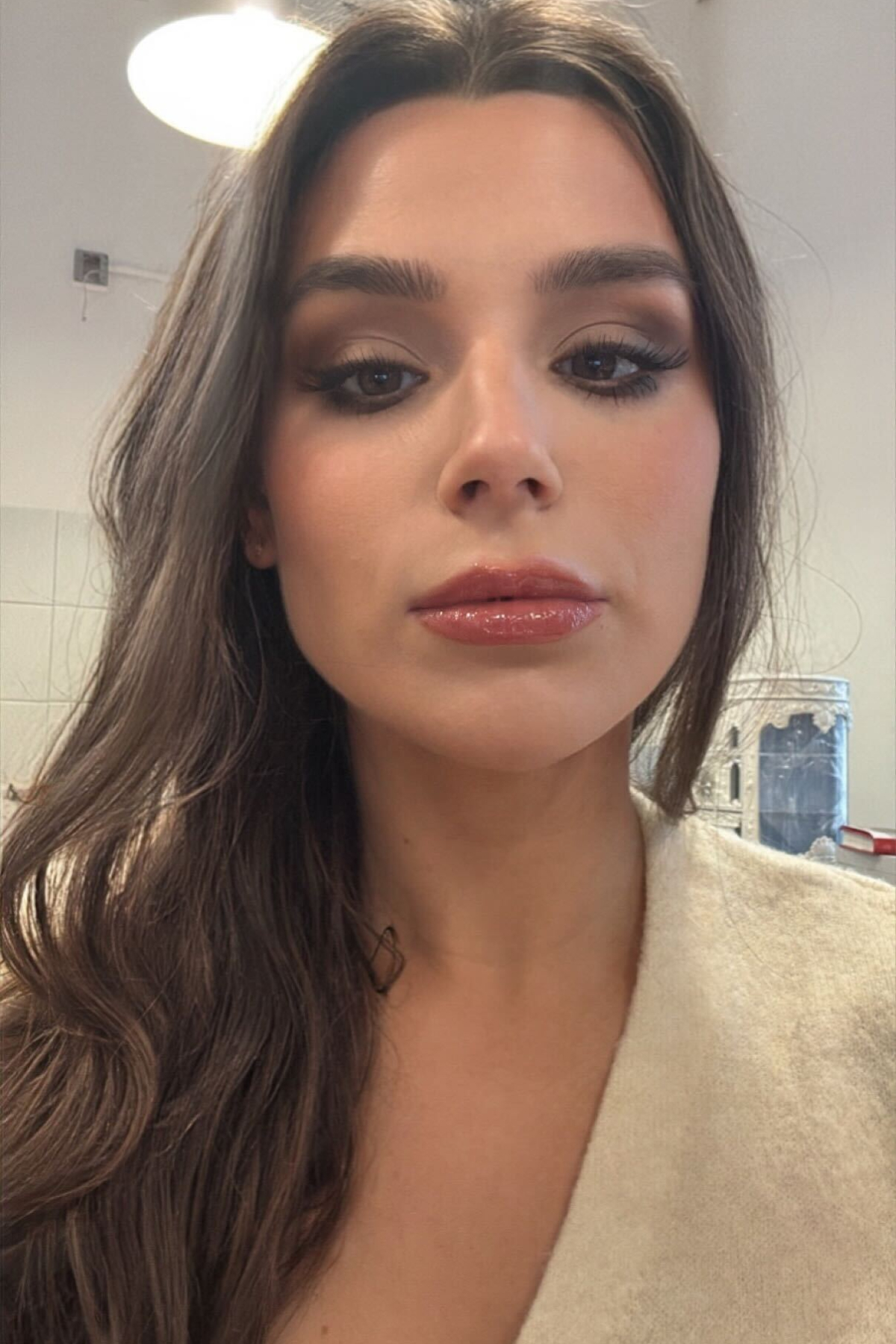 Siena Gagliano after testing the Giorgio Armani Luminous Silk Natural Glow Foundation in a cream sweater and brown hair.