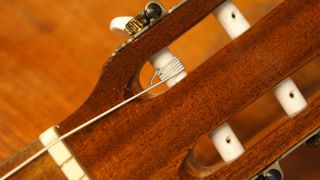 Securing a classical guitar string to a string post