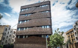 the handmade brick façade of the House of 40 knots is an improvisational affair