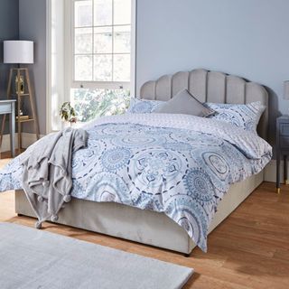 bedroom with wooden flooring and blue wall