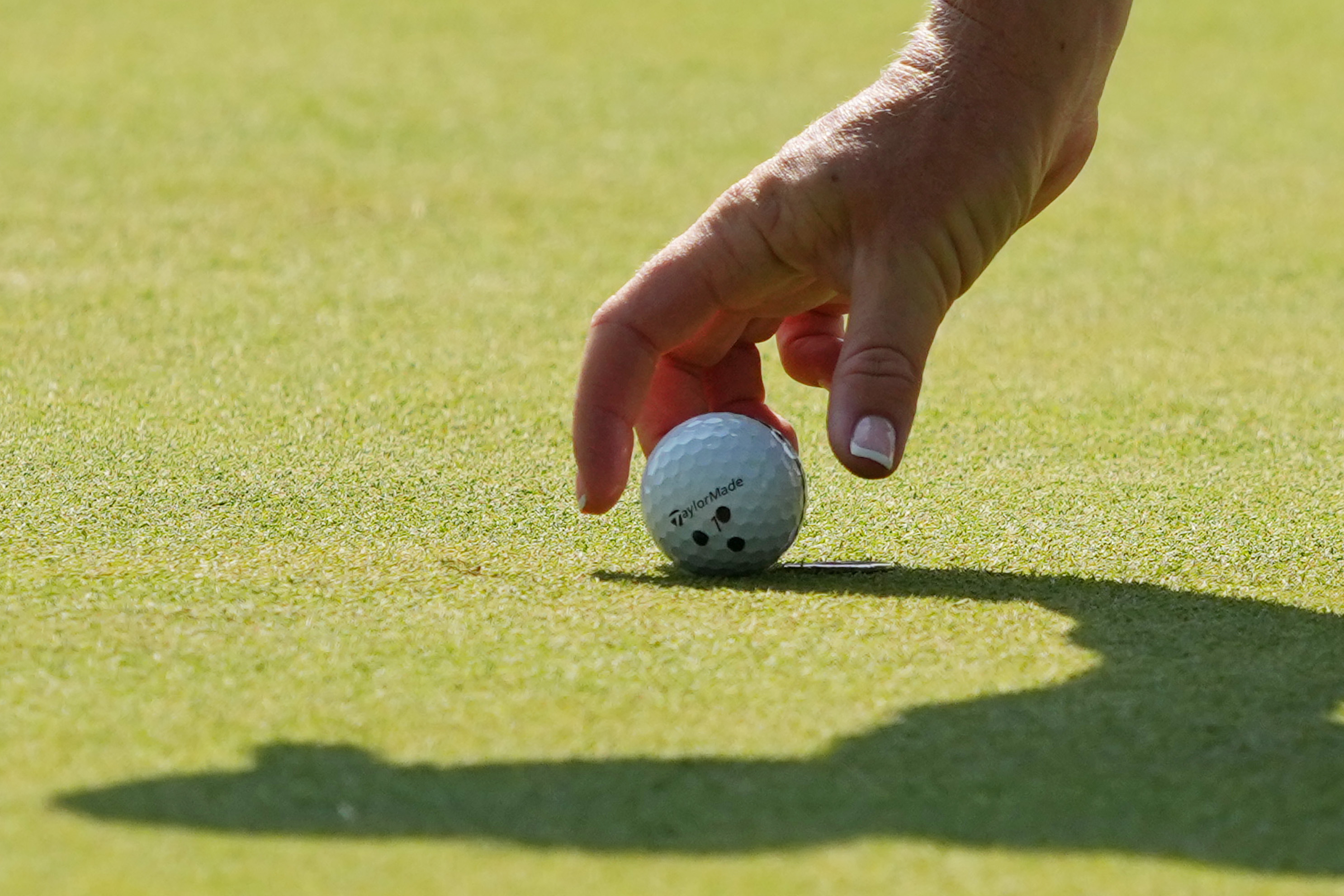 Charley Hull lines up a putt on the green