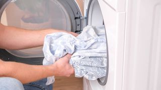 Clothes being unloaded from a clothes dryer