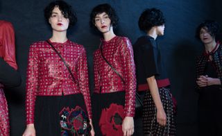 Models wearing red patterned jackets, with black velvet and flower embroidered pants, from Emporio Armani A/W 2015 collection.