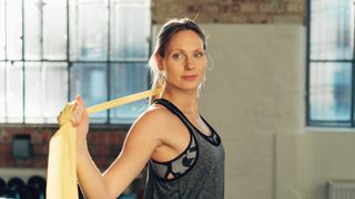 A woman doing back exercises with resistance band