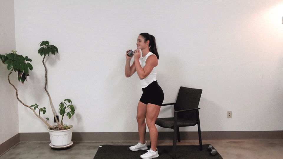 trainer Kirra Mitlo doing a dumbbell chair squat