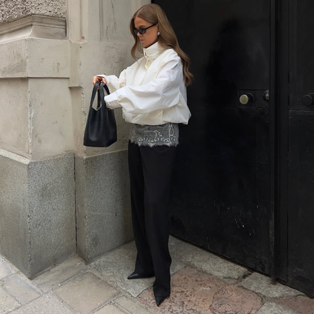Influencer HANNA JOHANSSON wearing a cropped jacket, black trousers and heels.