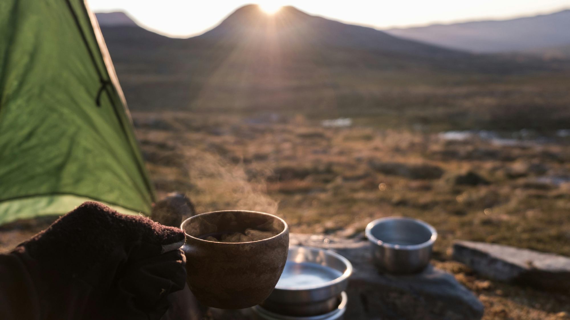 Person in tent with coffee 