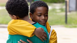 Two boys hug in &quot;We Grown Now&quot;