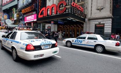 Police cars park outside a New York City movie theater
