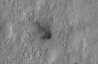 This image shows the crash site of the Mars rover Curiosity's sky crane, the rocket-powered backpack that lowered Curiosity down to the Martian surface on Aug. 5 PDT, 2012. Image released Aug. 7.