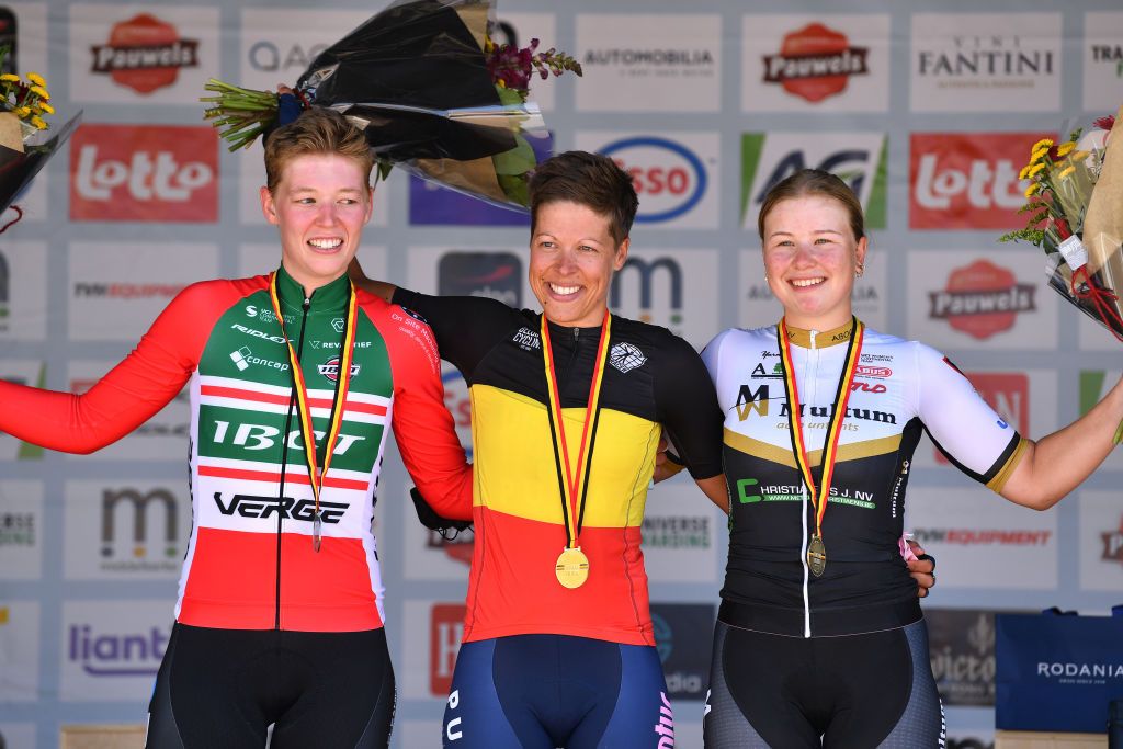 MIDDELKERKE BELGIUM JUNE 26 Silver medalist Fien Van Eynde of Belgium and Team IBCT gold medalist Kim De Baat of Belgium and Team PlanturPura and bronze medalist Sara Maes of Belgium and Multum Accountants Ladies Cycling Team pose on the podium during the medal ceremony after the 123rd Belgian Road Championship 2022 Womens Road Race a 1199km one day race from Middelkerke to Middelkerke BKMiddelkerke on June 26 2022 in Middelkerke Belgium Photo by Luc ClaessenGetty Images