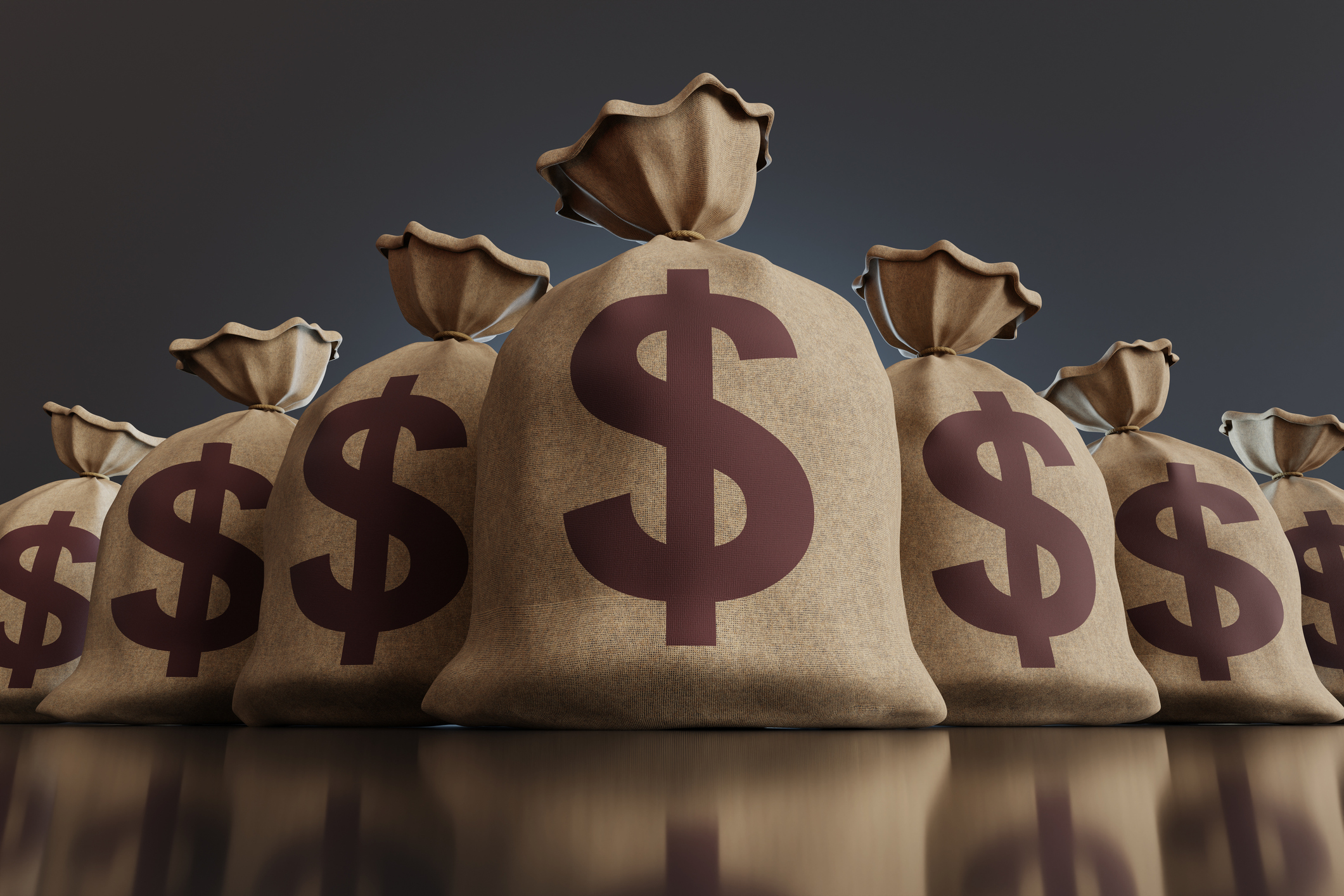Sacks of money on a reflective black floor in dark background. Illustration of the concept of money, investment, financial issues and economy