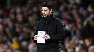 Arsenal manager Mikel Arteta holds a notepad during his side's defeat to West Ham in December 2023.