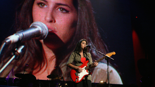 Amy Winehouse playing her red Fender Strat on stage at the wembley arena