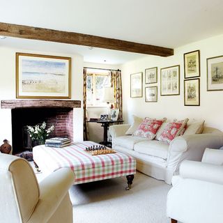 idyllic sussex farmhouse living room with sofa and armchairs footstool and carpet