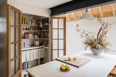 a small pantry with double doors 