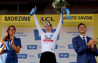 UAE Team Emirates' Slovenian rider Tadej Pogacar celebrates on the podium with the best young rider's white jersey after the 14th stage of the 110th edition of the Tour de France cycling race, 152 km between Annemasse and Morzine Les Portes du Soleil, in the French Alps, on July 15, 2023. (Photo by Thomas SAMSON / AFP)