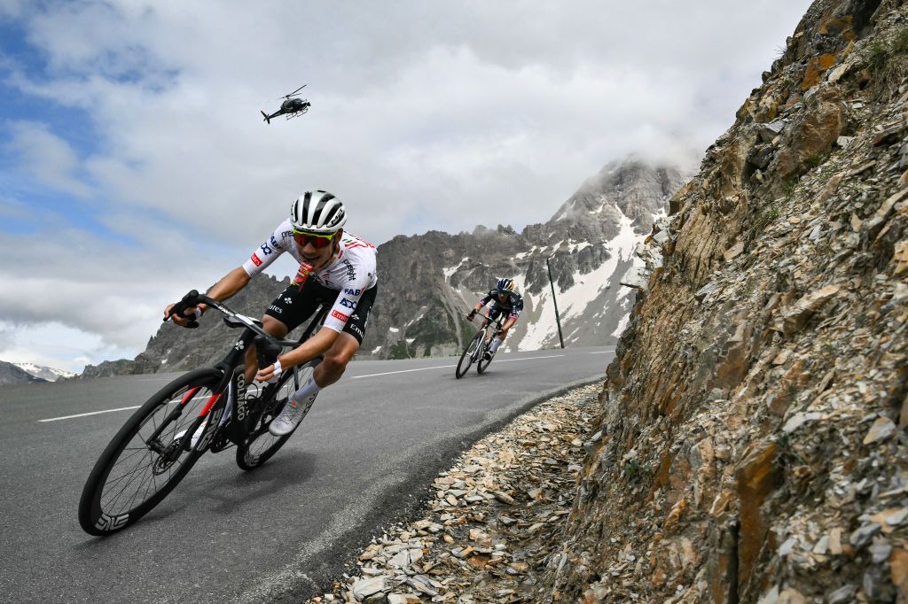UAE Team Emirates team's Portuguese rider Joao Almeida (L) and Red Bull - BORA - hansgrohe team's Slovenian rider Primoz Roglic cycles in the Galibier descent during the 4th stage of the 111th edition of the Tour de France cycling race, 140 km between Pinerolo in Italy, and Valloire in France, on July 2, 2024. (Photo by Marco BERTORELLO / AFP)