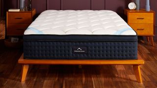 The DreamCloud Premier Hybrid mattress on a bed in a bedroom