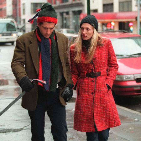 Carolyn Bessette Kennedy wears a red Prada coat