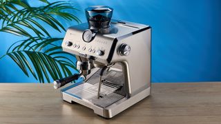 De'Longhi La Specialista Opera is a stainless steel manual espresso machine with smart tamping, a group handle, steam wand, and grinder