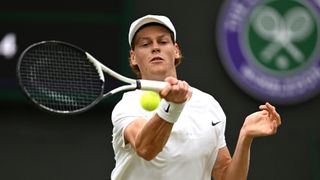 Jannik Sinner plays a shot at Wimbledon