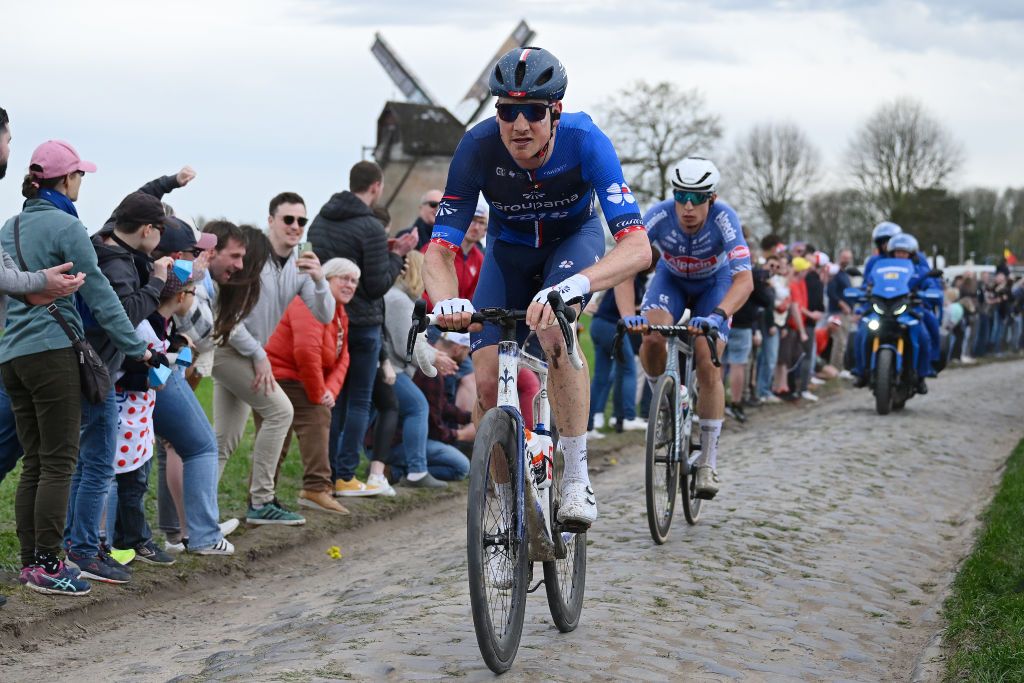 ROUBAIX FRANCE APRIL 07 LR Stefan Kung of Switzerland and Team Groupama FDJ and Jasper Philipsen of Belgium and Team Alpecin Deceuninck compete in the chase group passing through the Templeuve MoulindeVertain cobblestones sector while fans cheer during the 121st ParisRoubaix 2024 a 2597km one day race from Compiegne to Roubaix UCIWT on April 07 2024 in Roubaix France Photo by Dario BelingheriGetty Images