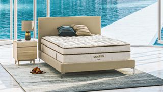 Saatva vs Bear mattress image shows the Saatva Classic hybrid on a beige bedframe overlooking a sparkling blue pool