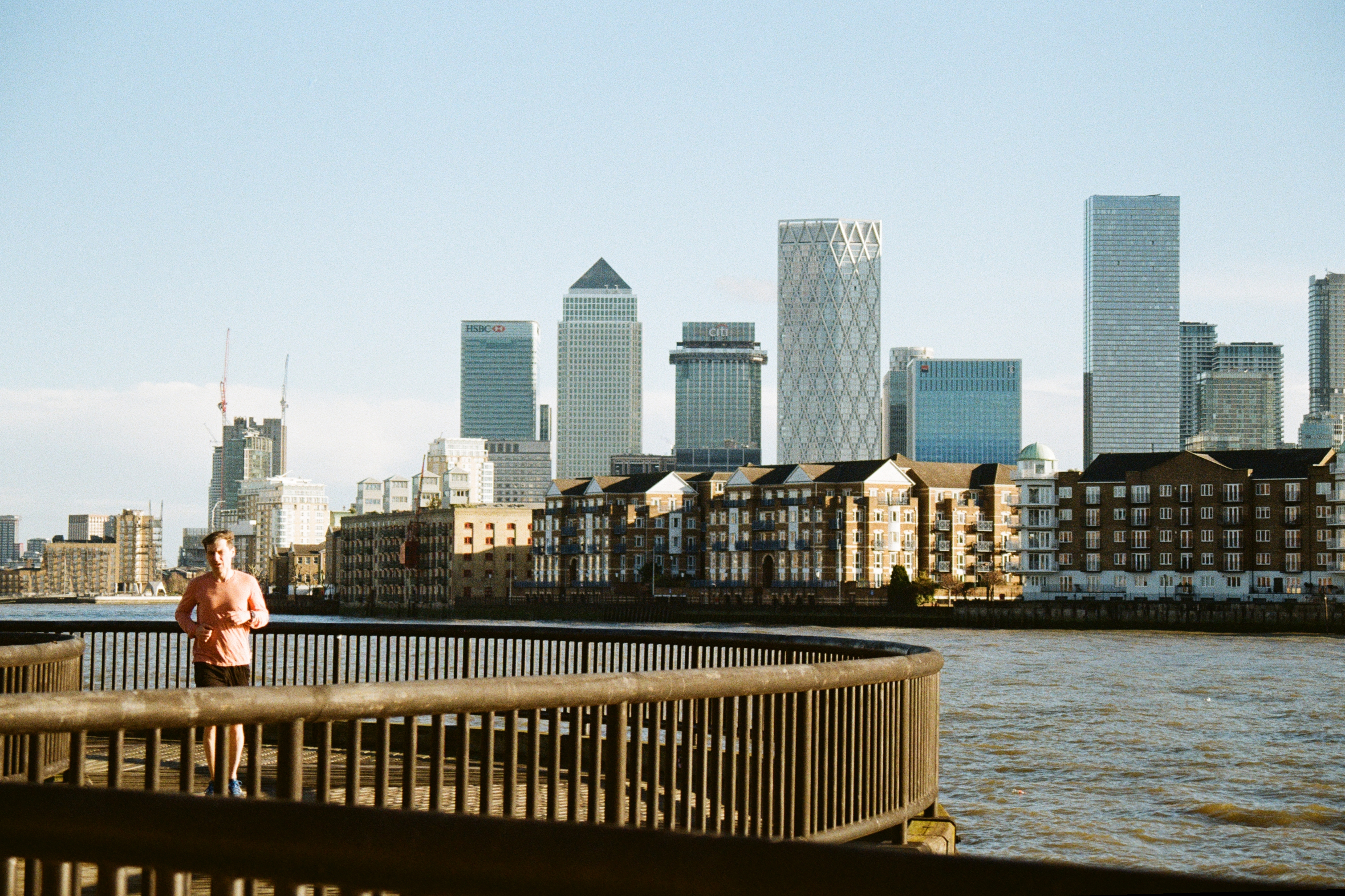 Sample photograph of Kodak Kodacolor 200 showing a jogger running in foreground and buildings of London's Canary Wharf across river visible in background