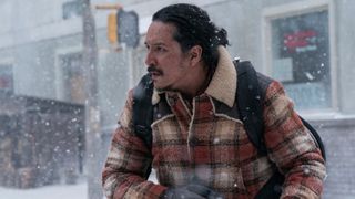 Tommy (Gabriel Luna) stands in a street amid the snow in "The Last Of Us" season 2