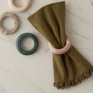 Napkin rings with a green napkin in center