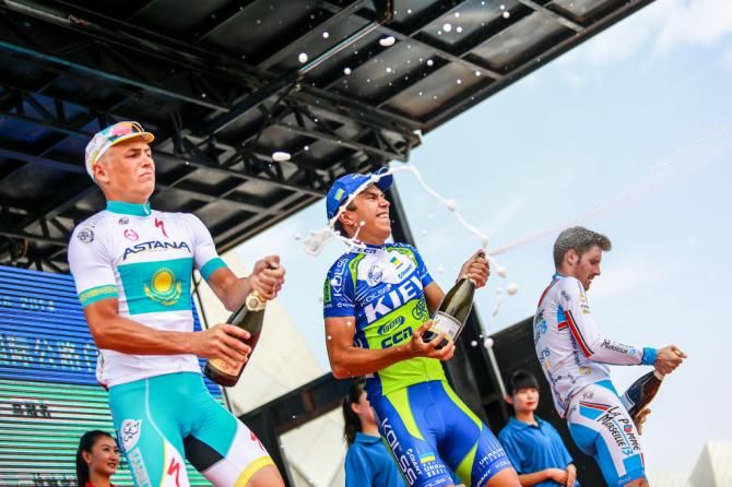 The top three from stage 1 spraying champagne