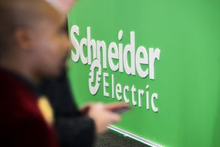 Schneider Electric logo and branding pictured at the Schneider Electric SE stand at the Enlit energy conference in Cape Town, South Africa, on Tuesday, May 16, 2023