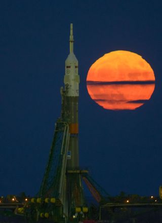 A supermoon full moon rises over a Russian Soyuz rocket carrying the Expedition 50 space station crew at Baikonur Cosmodrome, Kazakhstan on Nov. 14, 2016. The first of three upcoming back-to-back supermoons will rise on Dec. 3, 2017, NASA says.
