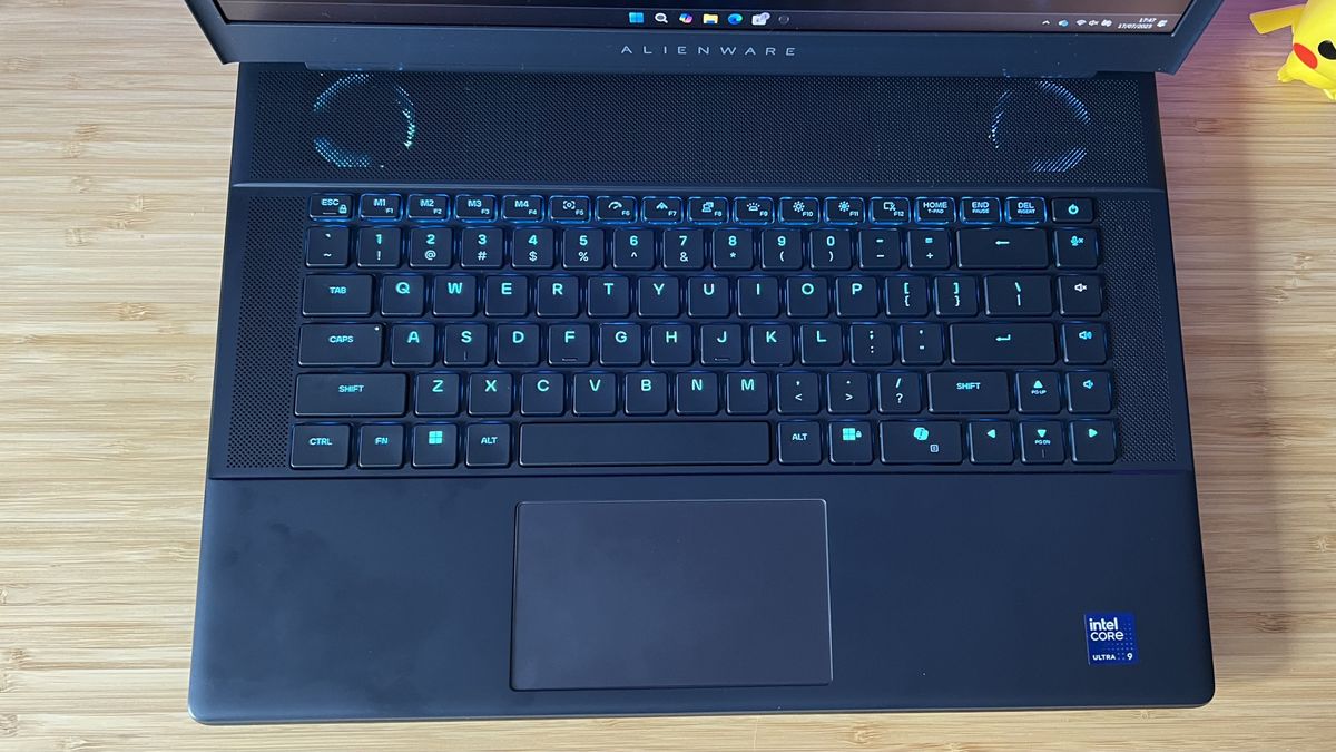 Top down view of Alienware 16 Area-51 gaming laptop keyboard and trackpad on a wooden desk