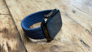 Apple Watch Series 8 with Komo Woven Band on wooden table