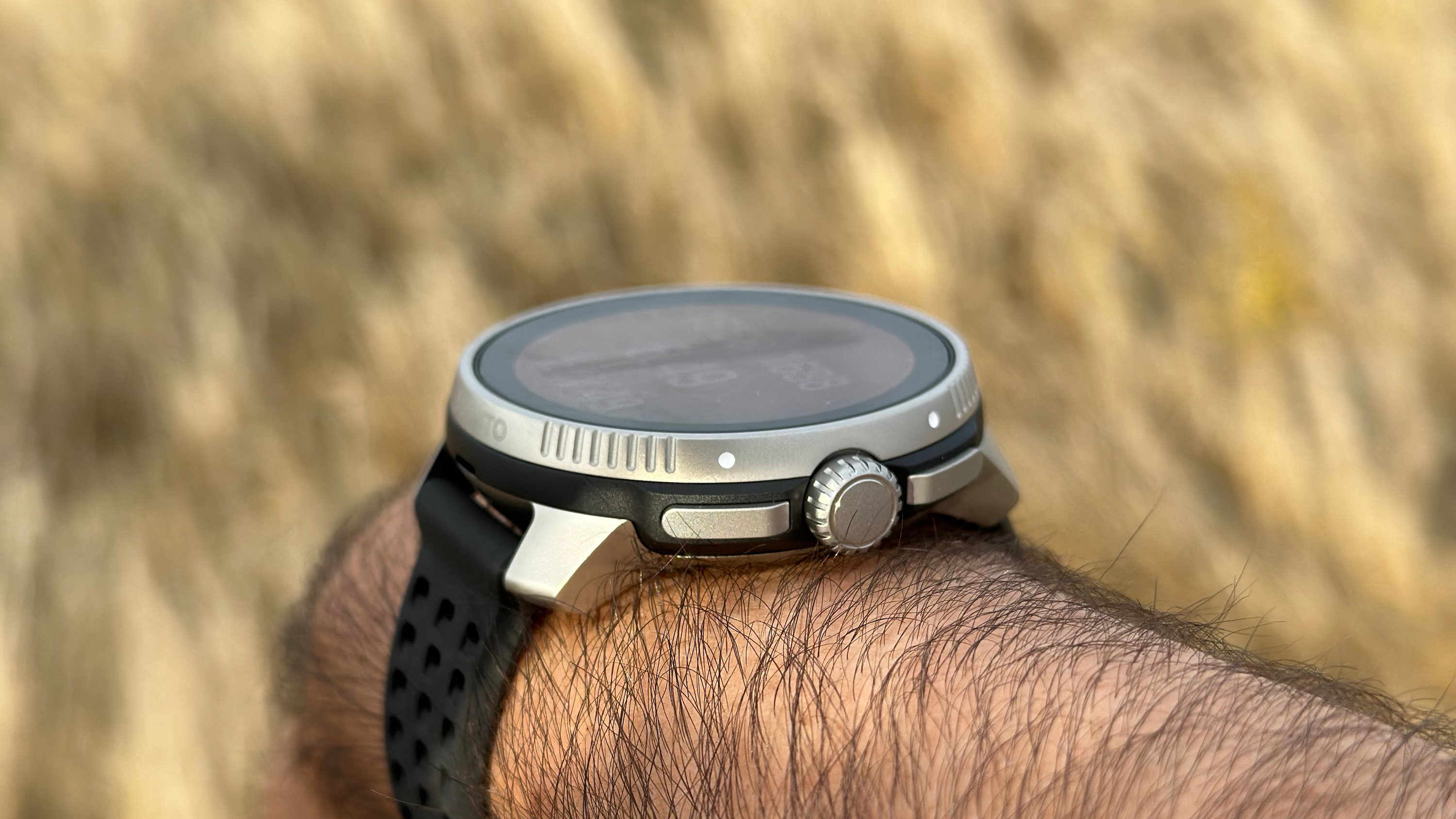 A side view of the Suunto Race focused on the crown and buttons.