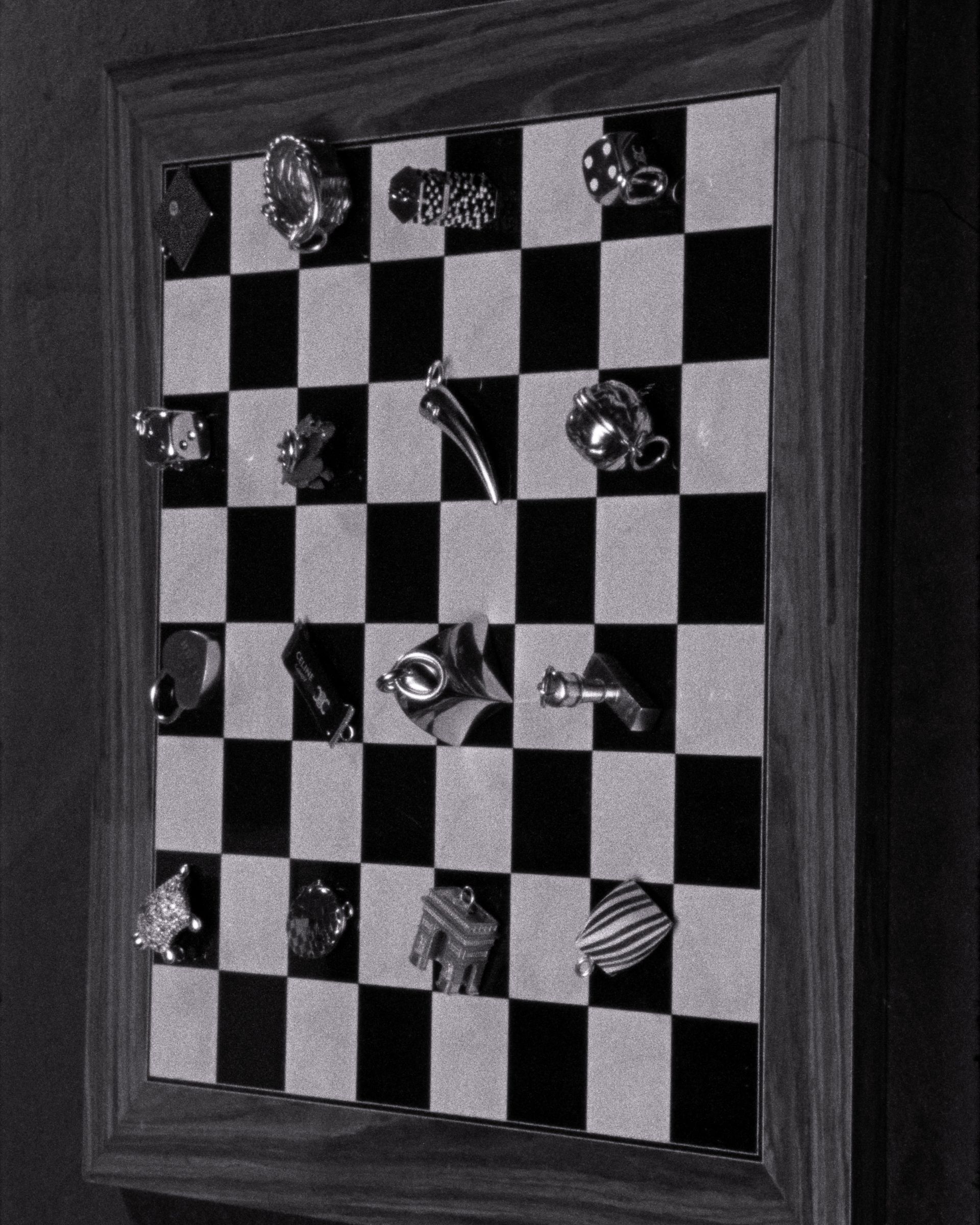 Celine charms on a chess board.