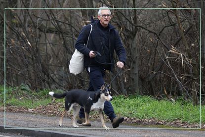 a medium shot of Gary Lineker walking his dog after the BBC Match of the Day row