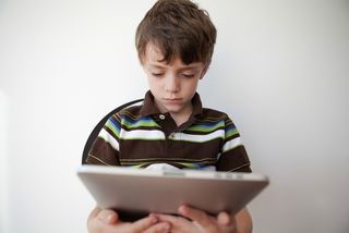 child looking at an ipad