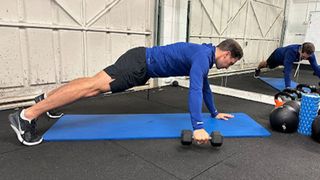 Personal trainer at Bio-Synergy Jay Conroy performs a static lunge with twist